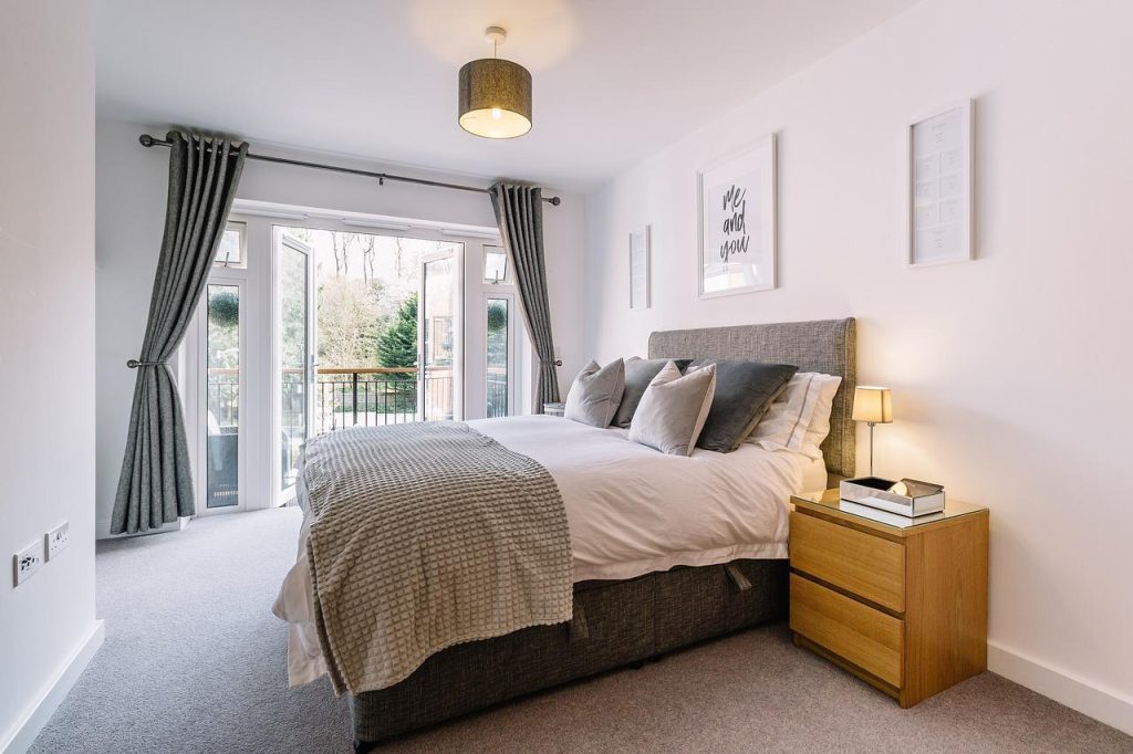 Slaapkamer met houttinten, houten bed en neutrale muurtint voor een warme, rustgevende sfeer